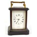 ARNOLD & LEWIS; an mahogany cased carriage clock, with broken swan neck folding handle above the