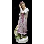 MEISSEN; a 20th century figure of a young girl holding a wide brimmed hat in her right hand, painted