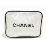 CHANEL; a white coated plastic zip around make up bag/pouch case with black 'Chanel' logo, with