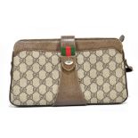 GUCCI; a GG monogrammed brown coated canvas shoulder bag with silver and gold tone maker's logo to