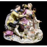 MEISSEN; a late 19th century figure group of young lovers modelled seated with two lambs by their