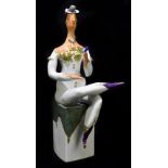 MEISSEN; a 20th century abstract figure modelled as a lady seated upon a column, designed by