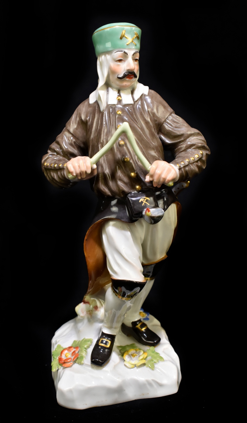 MEISSEN; an early 20th century figure of a Saxon miner with divining rod, after the original by