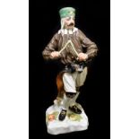 MEISSEN; an early 20th century figure of a Saxon miner with divining rod, after the original by