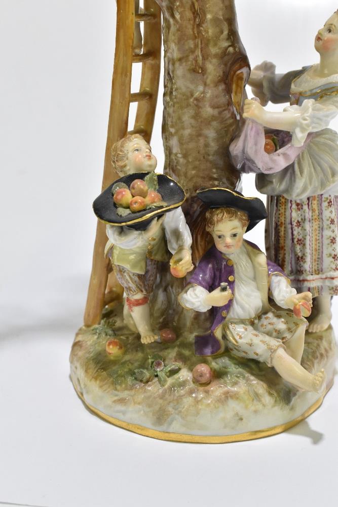 MEISSEN; an early 20th century figure group of a figure picking apples in an apple tree with three - Image 2 of 13