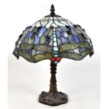 A Tiffany style lamp, with stained glass dragonfly shade, decorated with coloured cabochons,