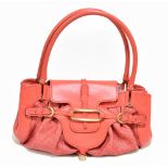 JIMMY CHOO; an orange leather and embossed cloth handbag with gold tone hardware logo front buckles,