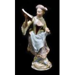 MEISSEN; an early 20th century figure of a young woman reading a music score, painted marks to base,