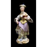 MEISSEN; an early 20th century figure of a woman reading a book, painted marks to base, painted