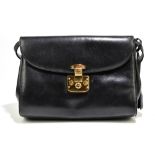 GUCCI; a black leather cross-body bag with top flap fastening, gold tone hardware closure with