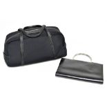 TRUSSARDI; a black cloth and leather bowling style bag with two top handles, silver tone zip with