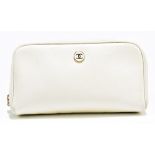 CHANEL; a cream textured leather make up bag with zip top, gold tone enamel maker's logo to front,