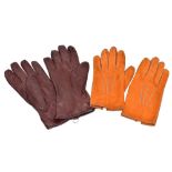 HERMÈS; a pair of orange soft suede Agneau lambskin lined lady's gloves, size 6.5, and a pair of