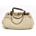 YOHJI YAMAMOTO; a beige and cream canvas handbag with brown calfskin leather looped ties and twin