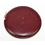 CARTIER; a Must de Cartier burgundy leather coin purse with gold tone hardware, zip stamped with