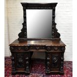 A large late Victorian oak mirror back sideboard, the elaborate rectangular plate above an invert