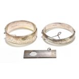 Two silver foliate engraved hinged snap bangles, one with presentation inscription and a silver