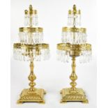 A pair of 20th century gilt brass table lamps, each with suspending three tiers of glass droplets,