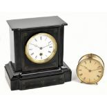 A Victorian black slate mantel clock, the circular enamelled dial set with Roman numerals, height