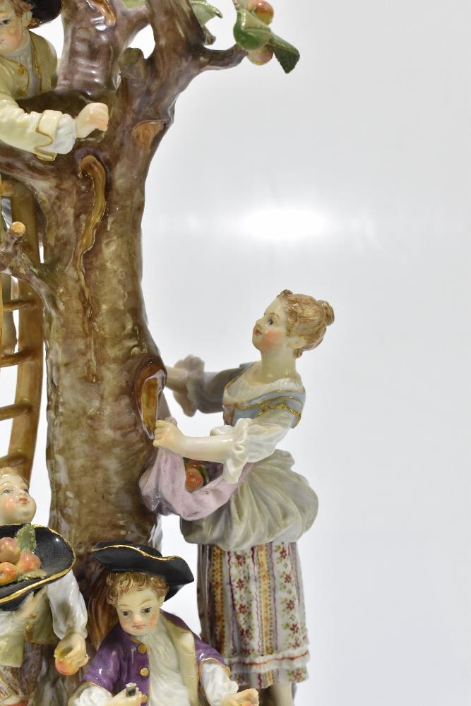 MEISSEN; an early 20th century figure group of a figure picking apples in an apple tree with three - Image 3 of 13