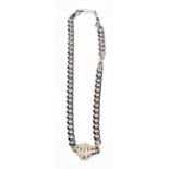 CHRISTIAN DIOR; a heavy vintage silver tone chain link necklace with gold and silver tone pendant,