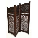 A carved hardwood two fold three section folding screen decorated with exotic birds and scrolling