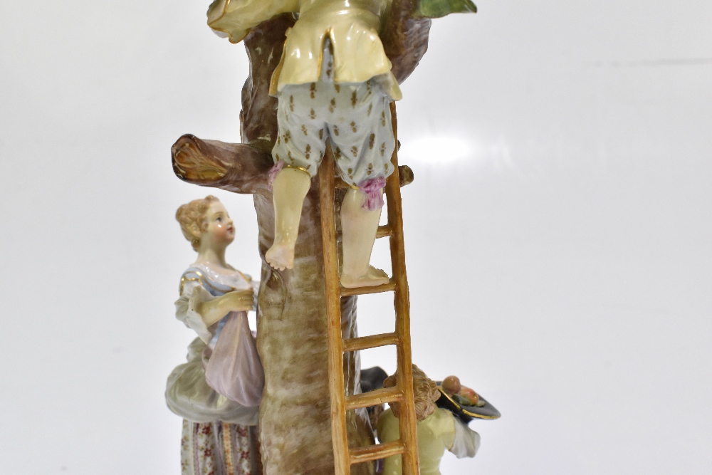 MEISSEN; an early 20th century figure group of a figure picking apples in an apple tree with three - Image 10 of 13