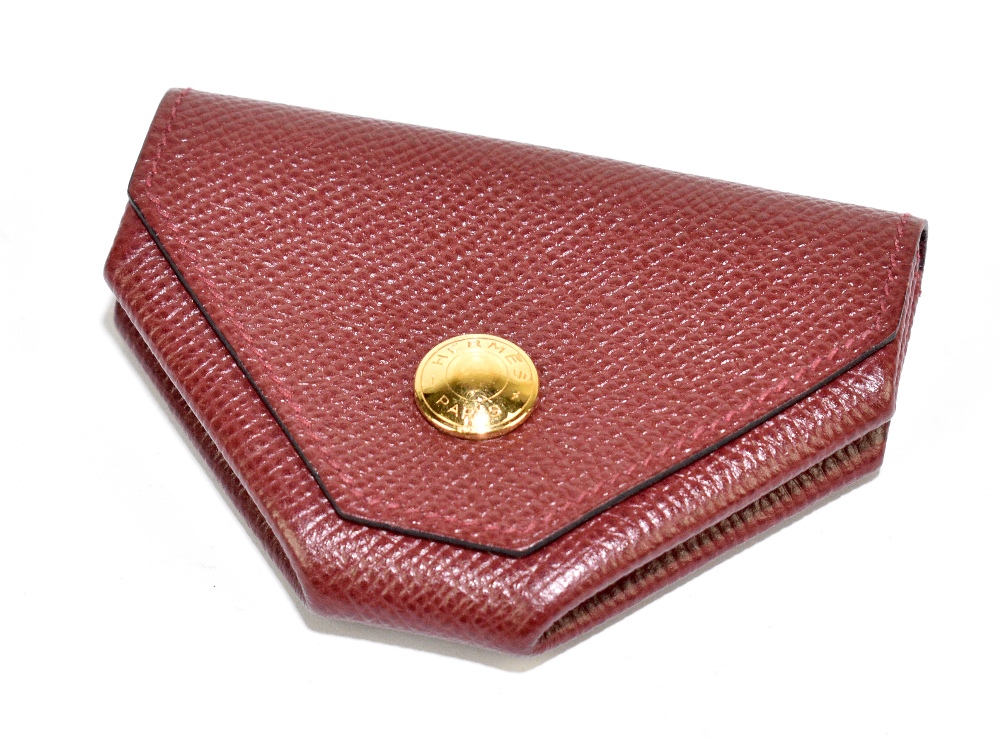 HERMÈS; a burgundy Epsom red calfskin leather coin purse with a gold Cloud de Selle clasp, with dust