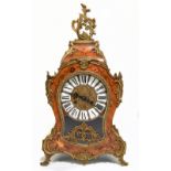 A large decorative French inspired inlaid kingwood veneered and brass mounted mantel clock with