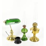 A modern brass desk lamp with green glass shade with two oil lamps including a moulded glass example