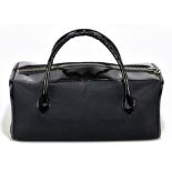 YOHJI YAMAMOTO; a black cloth and patent leather handbag with two D-handles, a silver tone zip to