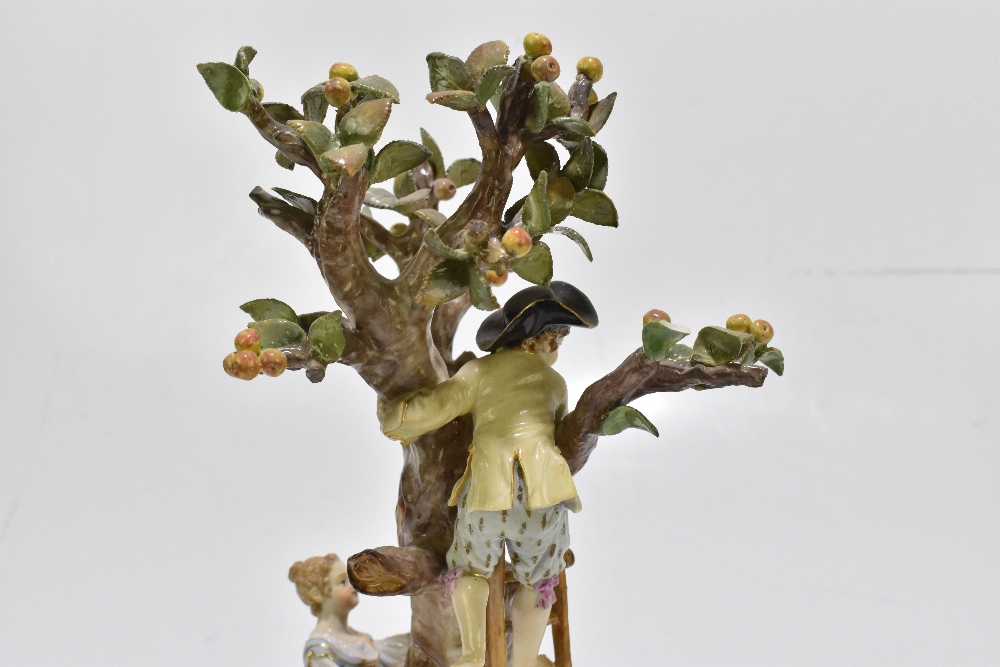 MEISSEN; an early 20th century figure group of a figure picking apples in an apple tree with three - Image 9 of 13