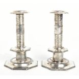 A pair of Carolean style silver plated candlesticks, of octagonal form, the underside of the bases