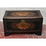 A mid 20th century camphor wood coffer with carved decoration, raised on bracket feet, width 90cm,