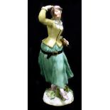 MEISSEN; an 18th century figure of a female with slapstick, painted marks to back of base, height