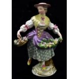 MEISSEN; an early 19th century figure of a woman with flowers in her apron and holding a basket in