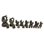 A collection of nineteen Burmese opium weights depicting various creatures, height of largest 12.