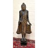 A large carved and part gilded figure of Buddha with jewelled detail, raised on plinth base,