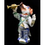 MEISSEN; a 20th century figure of a pig playing the trumpet, modelled by Peter Strang, painted marks