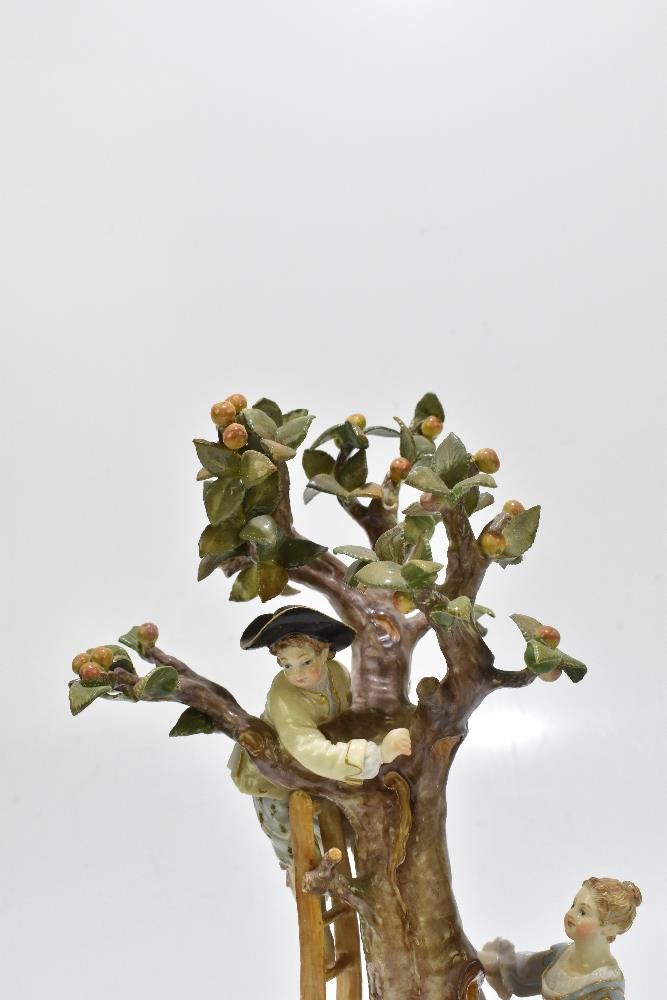 MEISSEN; an early 20th century figure group of a figure picking apples in an apple tree with three - Image 5 of 13