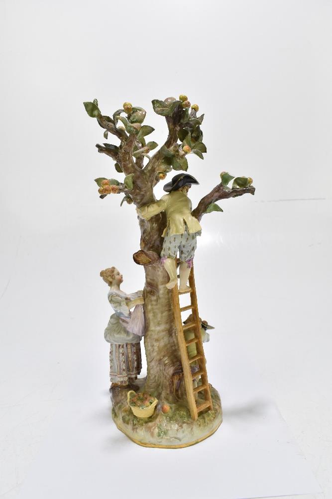 MEISSEN; an early 20th century figure group of a figure picking apples in an apple tree with three - Image 7 of 13