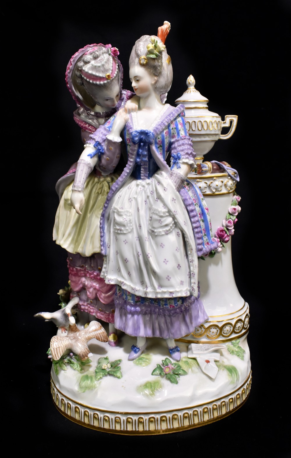 MEISSEN; a 20th century figure group of two young women wearing elaborate dress standing beside an