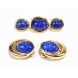 CHRISTIAN DIOR; a pair of gold tone vintage clip-on earrings with blue cabochon lapis lazuli stones,