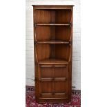 ERCOL; a medium elm freestanding corner cupboard with two fixed shelves above panel door, height