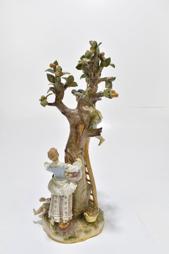 MEISSEN; an early 20th century figure group of a figure picking apples in an apple tree with three - Image 8 of 13