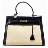 A vintage 1950s canvas and box blue leather handbag in the style of a Hermès Kelly 32 bag, with gold