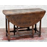 An 18th century oak drop leaf gateleg dining table, with single end drawers, raised on column