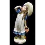 MEISSEN; a 20th century figure of a girl wearing wide brimmed hat and eating cherries from a basket,