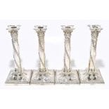 GOLDSMITHS & SILVERSMITHS CO; a set of four late 19th century silver plated Adam style candlesticks,