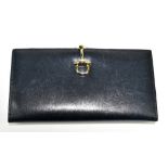 LAUNER; a navy blue soft calfskin leather wallet/purse with gold tone stirrup clasp, with card slots